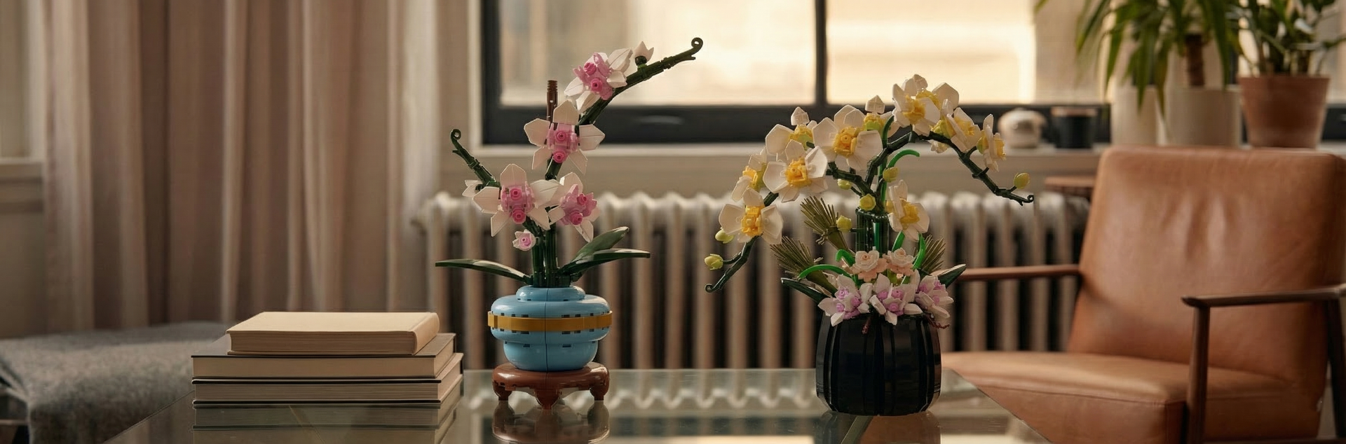 Two elegant Mavirea orchid building block sets—one in deep blue and one in soft yellow—placed on a glass table to showcase high-end floral art that never wilts.