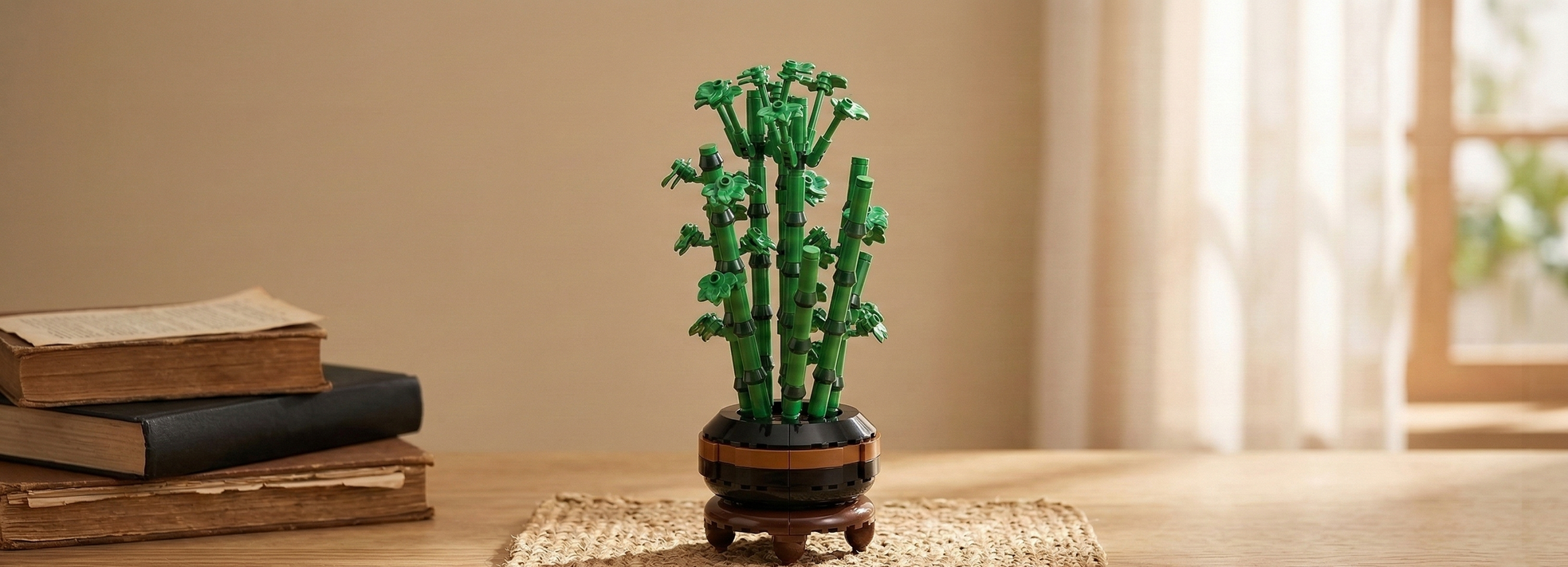 A Mavirea Bamboo Bonsai building set displayed on a wooden desk next to vintage books, reflecting a peaceful Zen aesthetic and serving as a thoughtful, long-lasting gift.