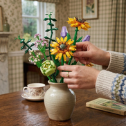 A completed Mavirea building block flower arrangement featuring sunflowers and lavender blooms in a light ceramic vase, serving as an elegant and everlasting interior accent.