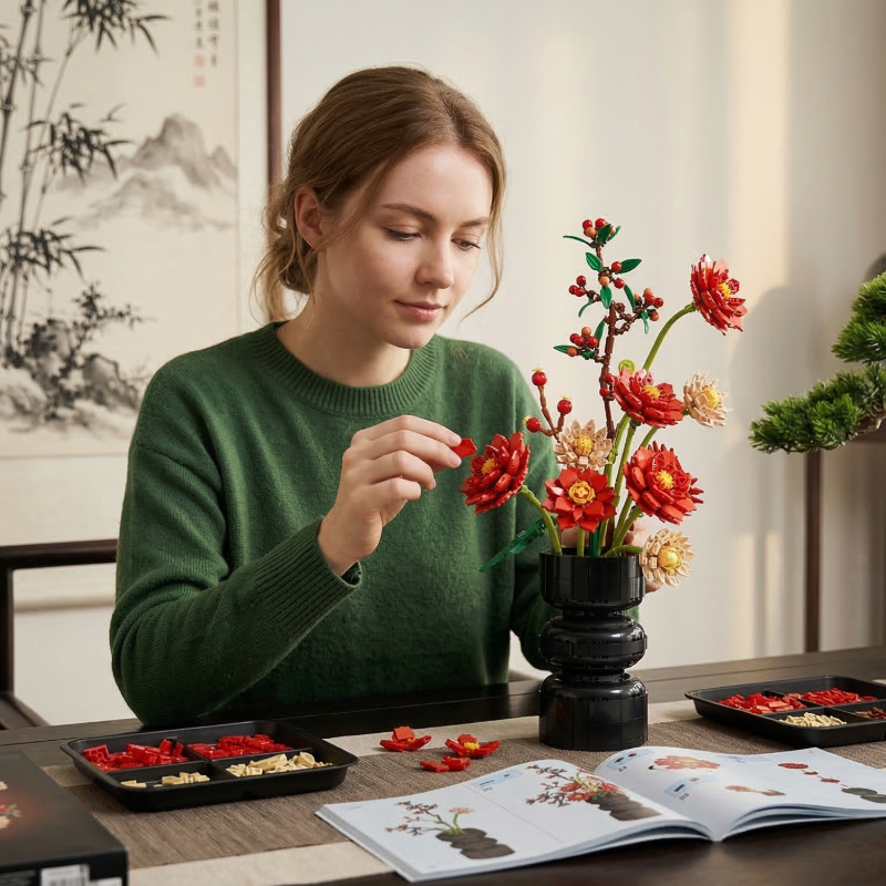 A woman in a green sweater assembling a Mavirea building block flower set, showcasing the mindful DIY experience of creating home ornaments.