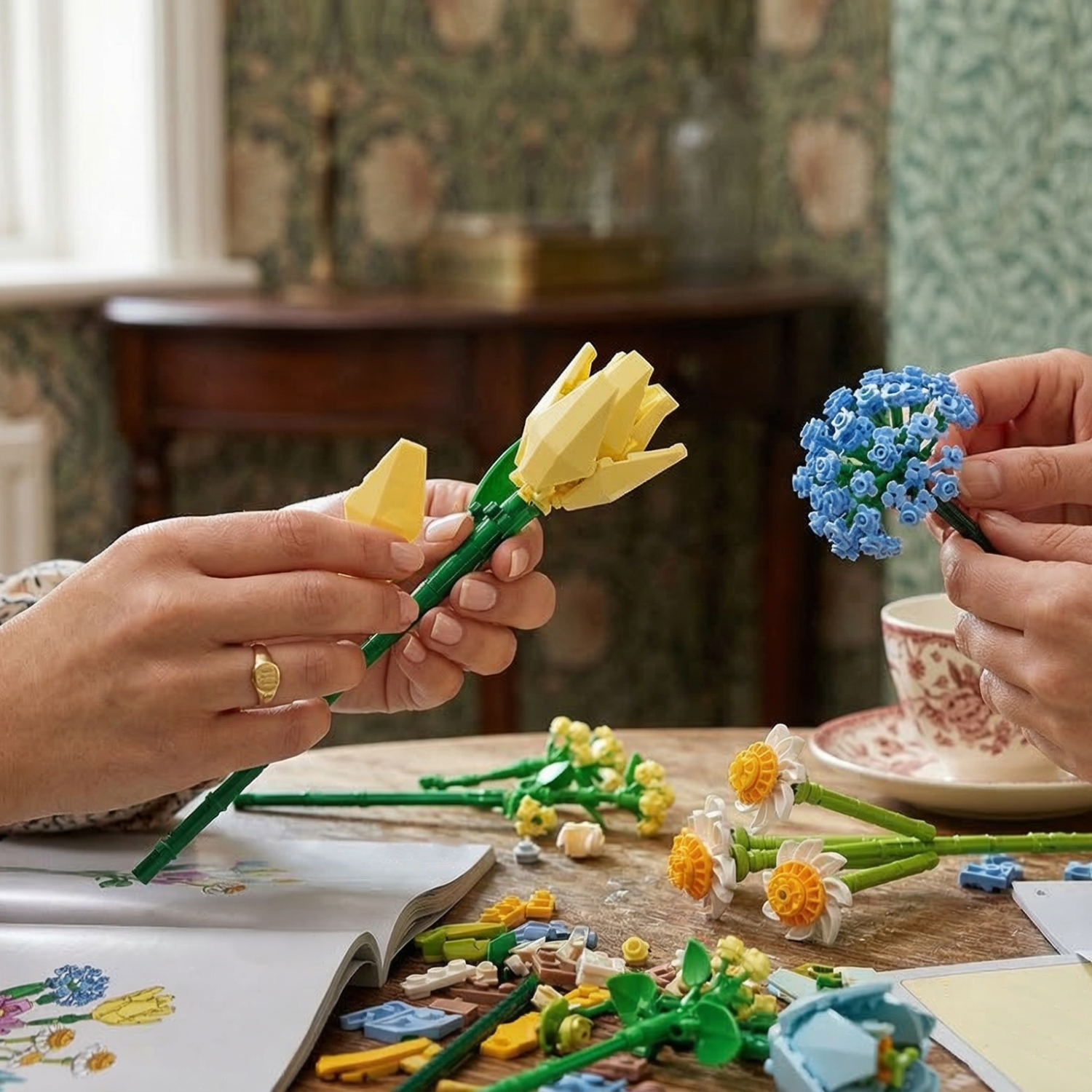 A close-up of hands carefully assembling Mavirea building block flowers, featuring a yellow tulip and a blue pom-pom bloom, emphasizing the detailed and creative DIY experience.