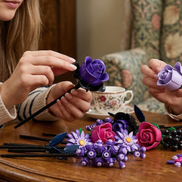 Hands carefully assembling Mavirea purple building block roses, showcasing the rich colors and intricate petal details of these creative, eternal floral gifts.