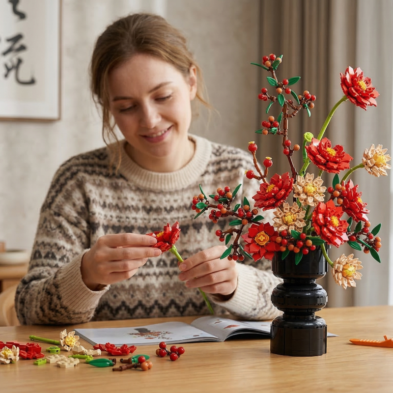 A smiling woman crafting a Mavirea red Dahlia brick flower, emphasizing the joy of building a personalized and everlasting floral gift.