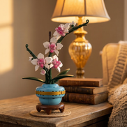 A building block orchid by Mavirea displayed next to vintage books under warm lamp light, illustrating a timeless and maintenance-free decorative gift.