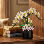 A Mavirea White Orchid building block set styled on a wooden shelf next to a stack of vintage books, perfect for timeless office or study styling.