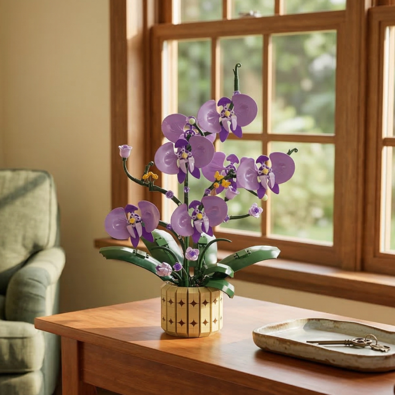 A bright, sunlit view of the Mavirea Potted Moth Orchid brick flowers placed on a wooden side table by a window, showcasing it as a vibrant and maintenance-free eternal gift for any living space.