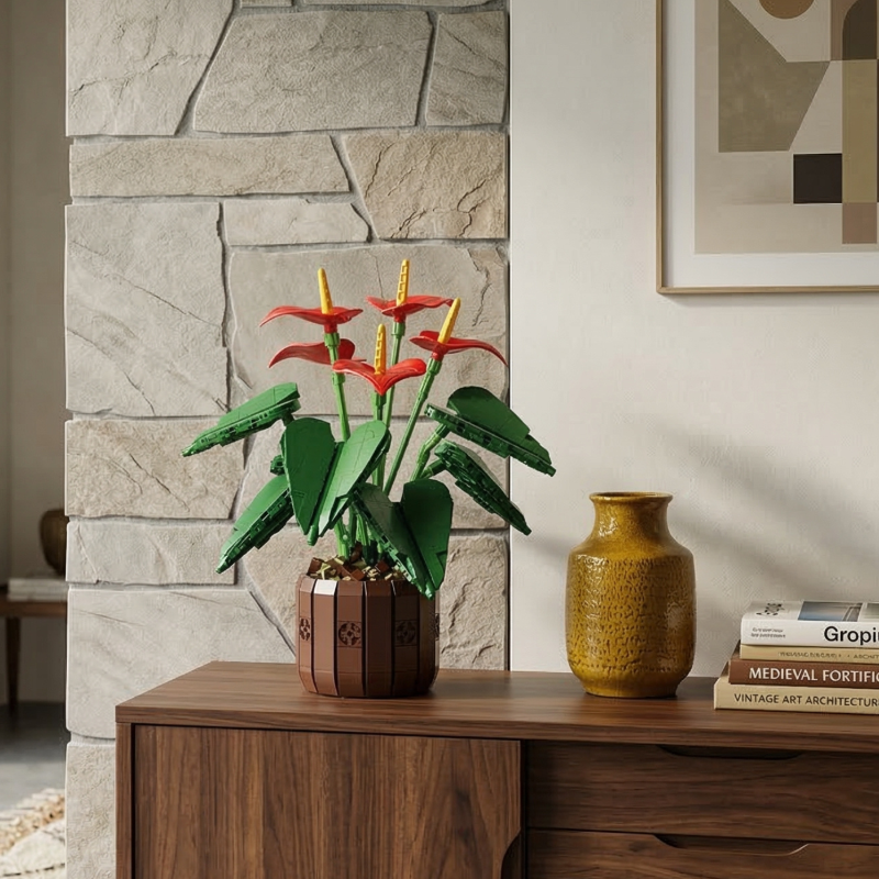The Mavirea Anthurium Bonsai brick-built plant displayed on a walnut cabinet alongside a yellow textured vase and art books, set against a rustic stone wall for a contemporary, artistic interior look.