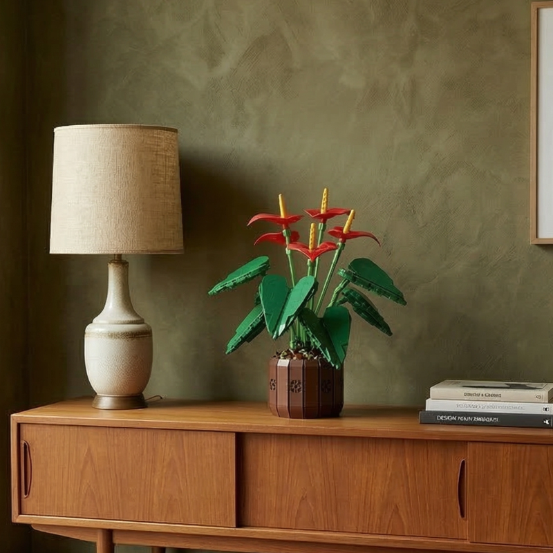 A warm and atmospheric scene featuring the Mavirea Anthurium Bonsai on a mid-century modern console, complemented by a stylish table lamp and an olive green textured wall for a cozy home aesthetic.