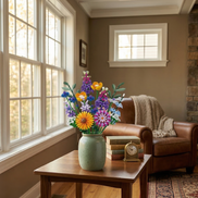 A light green matte vase holding the Hoshino Hana building block floral arrangement by Mavirea, placed on a side table next to a leather armchair to create a peaceful and permanent reading nook decor.