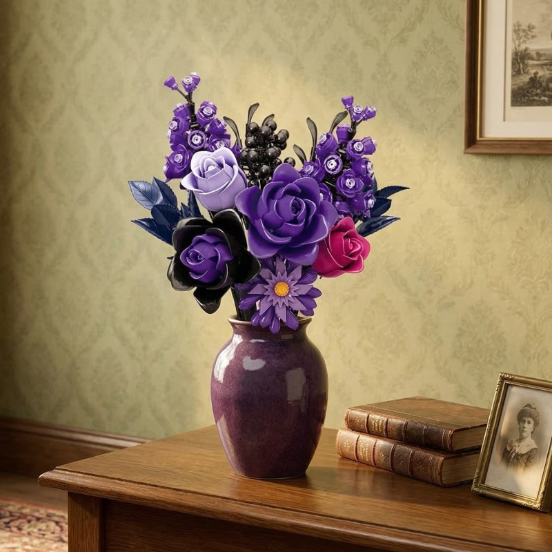 The Mavirea Purple Rose Whisper brick-built flowers displayed in a glossy purple ceramic vase, creating an elegant antique vibe on a wooden desk next to old books and a framed vintage portrait.