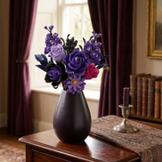 A moody and sophisticated interior scene showcasing the Mavirea Purple Rose Whisper bouquet in a dark teardrop vase, perfectly coordinated with deep purple curtains and a silver candlestick for romantic home decor.