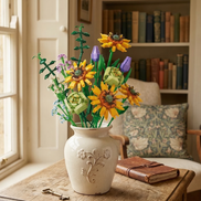 A bright Sunflower Serenade brick-built arrangement displayed near a cozy reading nook, showcasing its charm as a timeless and eternal gift.