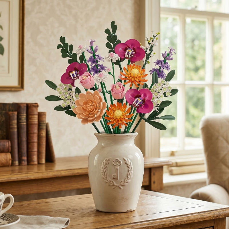An eternal Mavirea floral arrangement in a crest-embossed vase, styled with antique books for a sophisticated study accent.