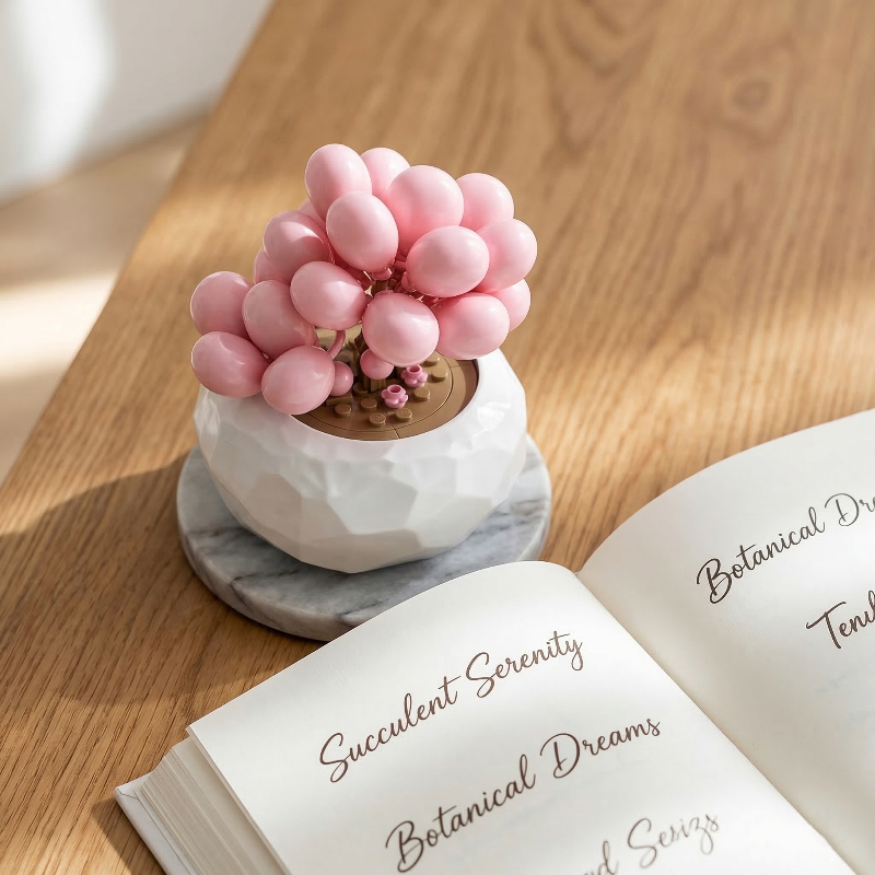 A pink Graptopetalum Amethystinum  succulent from Mavirea on a marble coaster next to an open botanical journal, creating a serene and modern decor vibe.