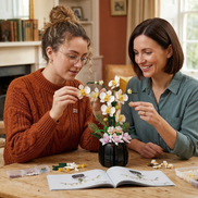 Two women happily assembling the Mavirea White Orchid building block set together, showcasing the joy of interactive DIY gifting and home decor.